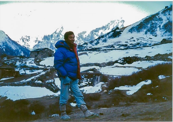 Photo of Dr. KUMAGAI against the background of Himalaya Mountains in his twenties