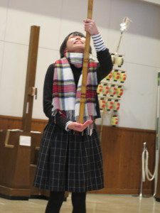 student practices balancing a kanto festival pole