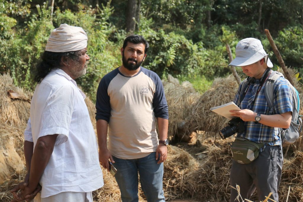 Picture of Dr. Natori and Dr. Varghese interacting with a local farmer
